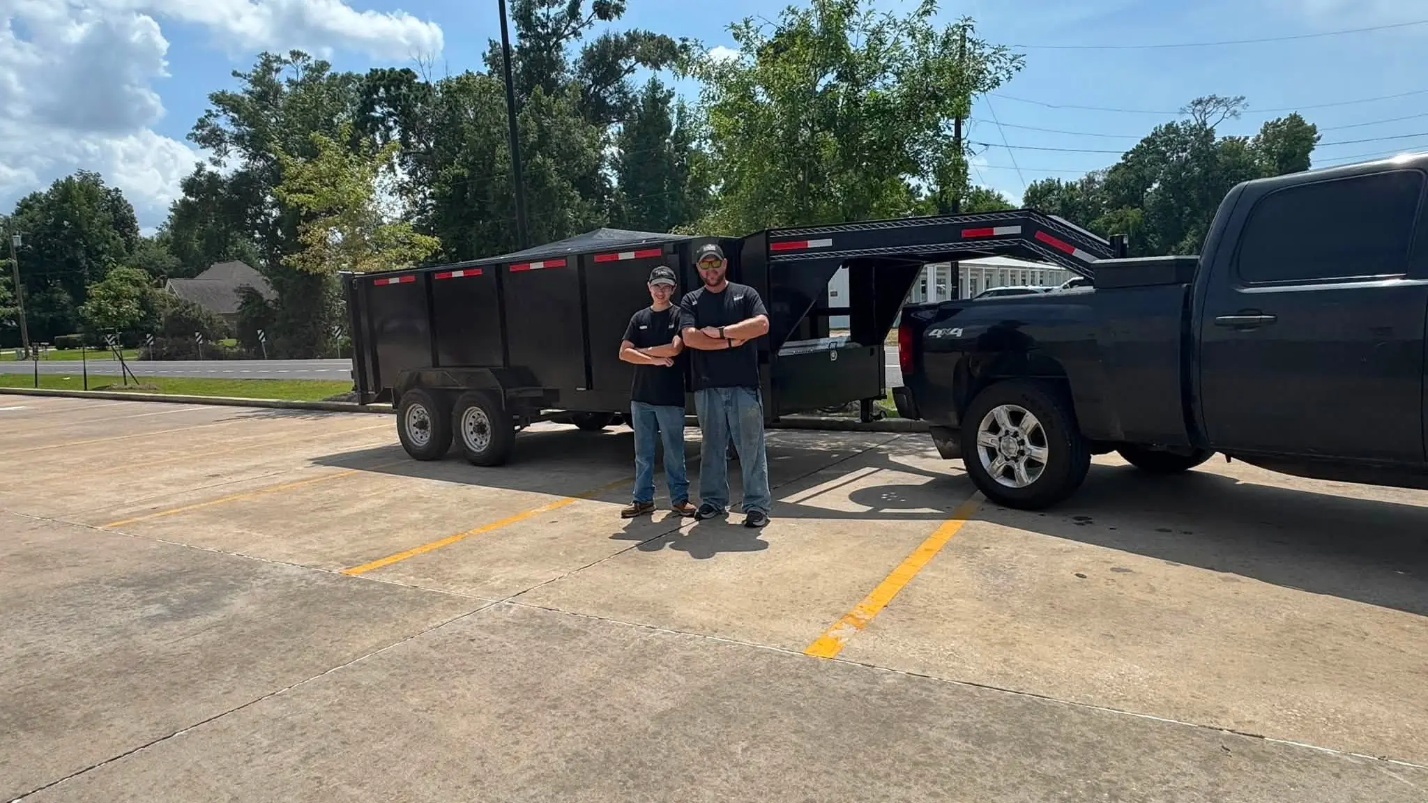 Klutter Krewe crew standing with the truck and dump trailer