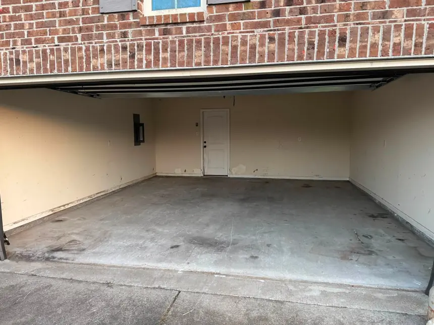 The same two-car garage emptied and swept to a bare floor