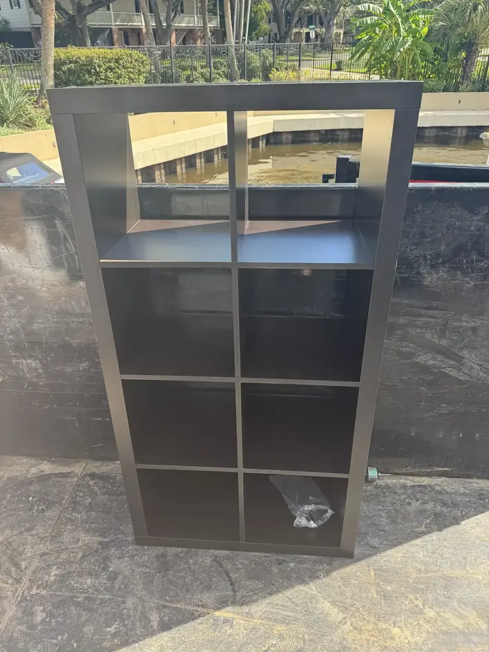 Tall cube shelving unit standing upright in the trailer