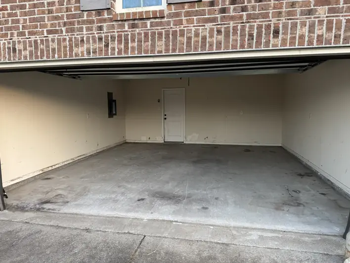 The same garage emptied and swept down to a bare slab